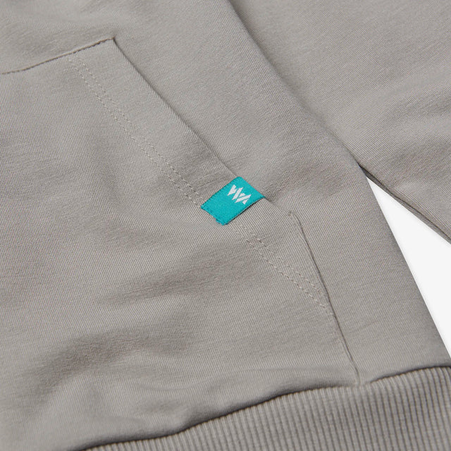 Close-up of the pocket detail on the Juniors' Boulder Zip Through Hoodie, showcasing functional and stylish design.