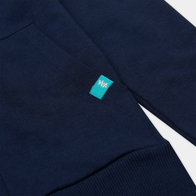 Pocket and branding detail on a Jellymud Junior Navy Bamboo Hoodie
