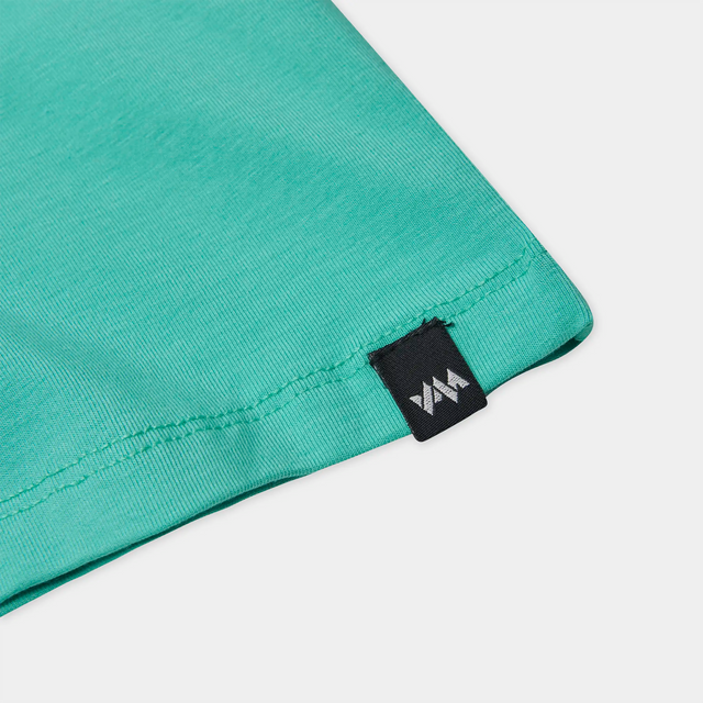 Close-up view of the woven branded hem label on the Kids' Bamboo Altitude T-Shirt.